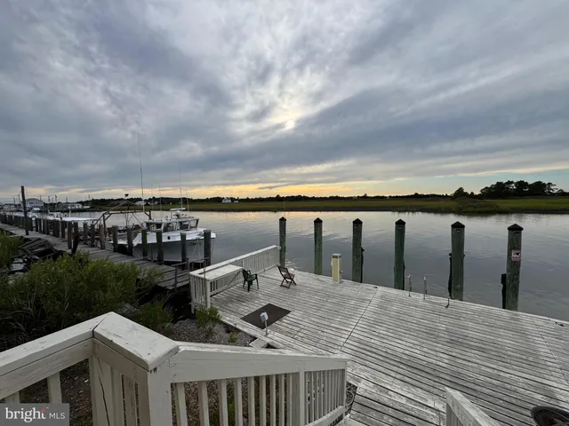 a view of roof deck with two chairs and wooden floor
