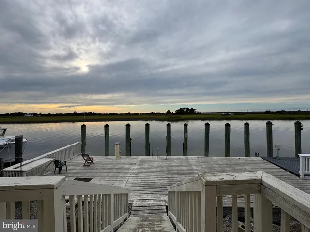 a view of roof deck with two chairs and wooden floor
