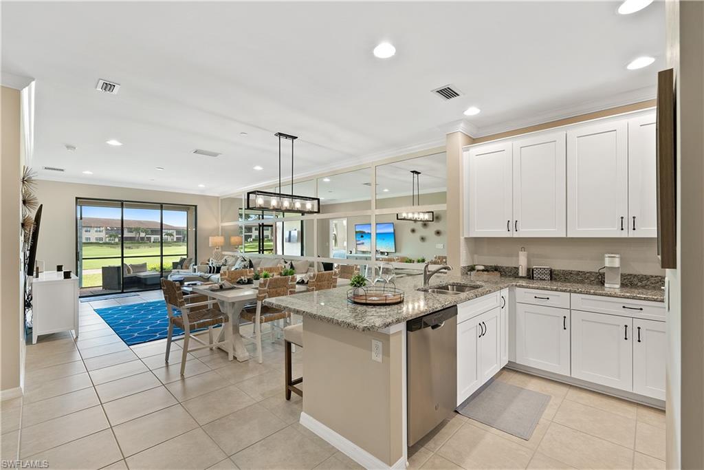 9386 Pocida Court, Unit 103 Naples, FL 34119 - Photo 13 of 43 a kitchen with a sink stove and cabinets