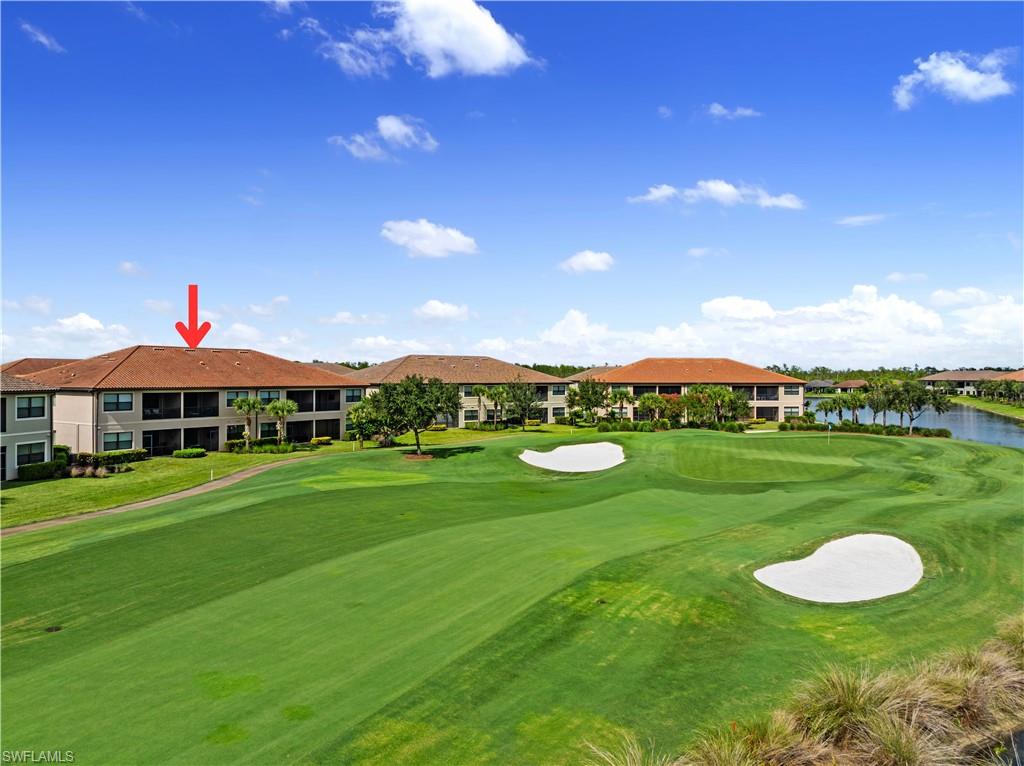 9386 Pocida Court, Unit 103 Naples, FL 34119 - Photo 21 of 43 a view of a big house with a big yard