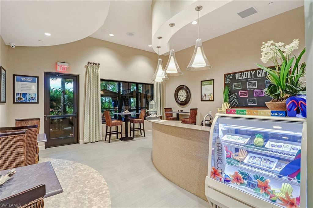 9386 Pocida Court, Unit 103 Naples, FL 34119 - Photo 29 of 43 a living room with furniture and a flat screen tv