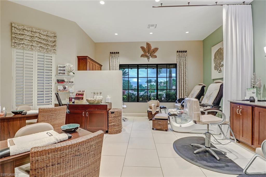 9386 Pocida Court, Unit 103 Naples, FL 34119 - Photo 34 of 43 a living room with furniture and floor to ceiling window