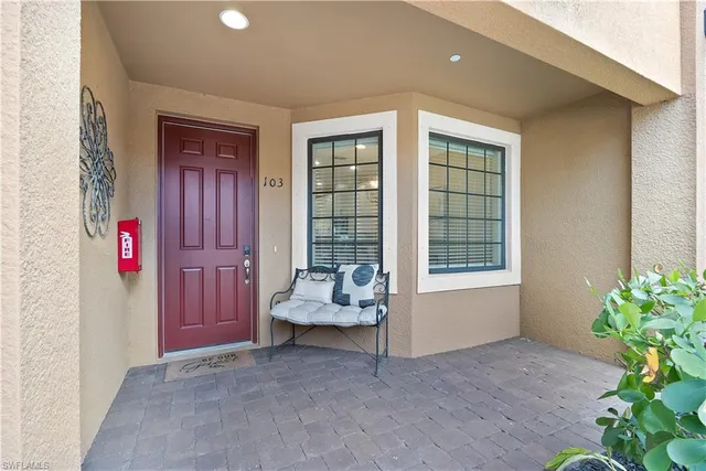 a living room with furniture and flowers