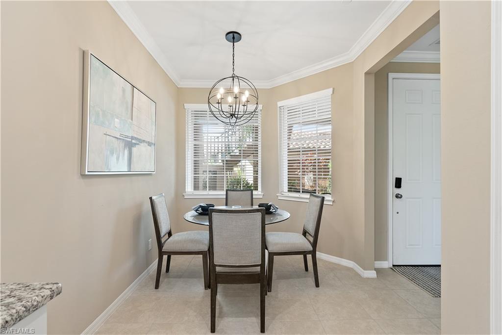 9386 Pocida Court, Unit 103 Naples, FL 34119 - Photo 7 of 43 a view of a dining room with furniture window and outside view