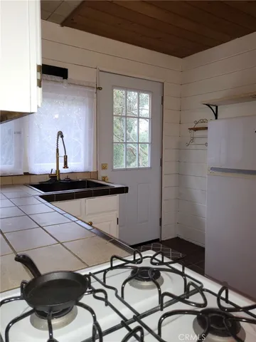 a kitchen with a sink a stove and a refrigerator