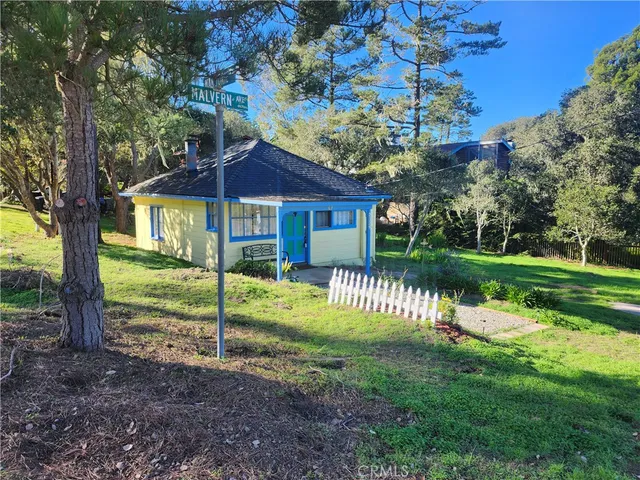 a front view of a house with a yard table and chairs