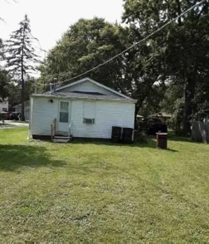 a front view of house with yard and trees