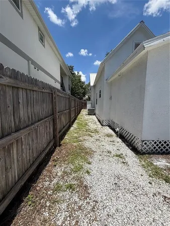 a view of a yard with plants and trees