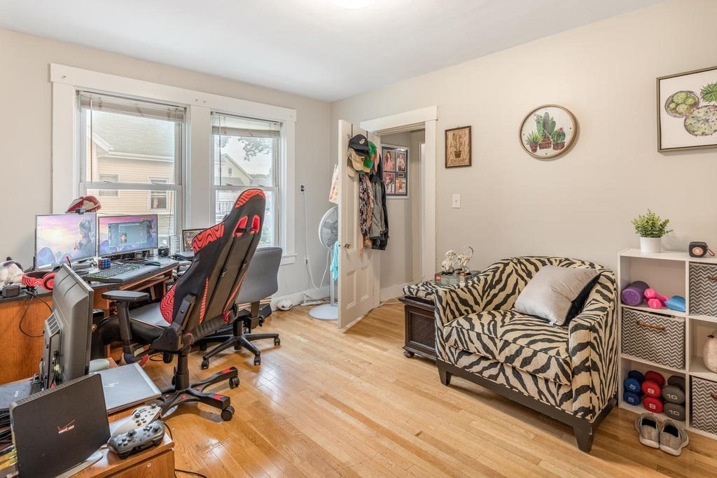109 Chestnut Street, Unit 109 Waltham, MA 02453 - Photo 12 of 18 a view of a workspace with furniture and a wooden floor