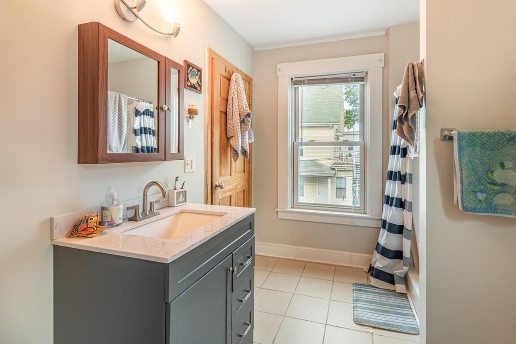 109 Chestnut Street, Unit 109 Waltham, MA 02453 - Photo 14 of 18 a bathroom with a sink and a mirror