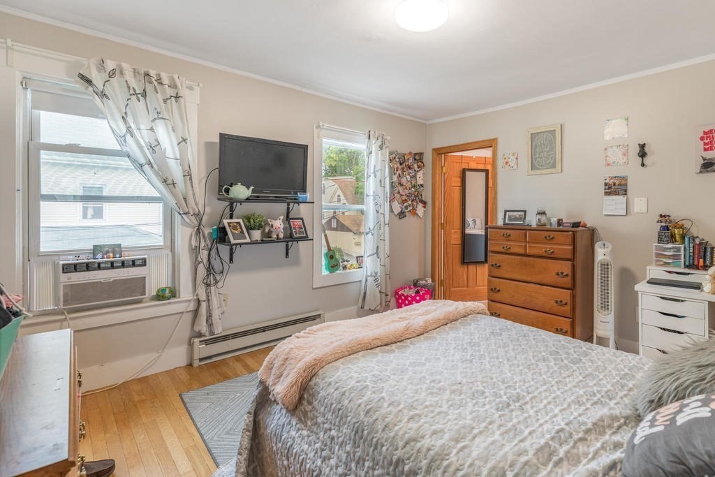 109 Chestnut Street, Unit 109 Waltham, MA 02453 - Photo 16 of 18 a bedroom with a bed and wooden floor