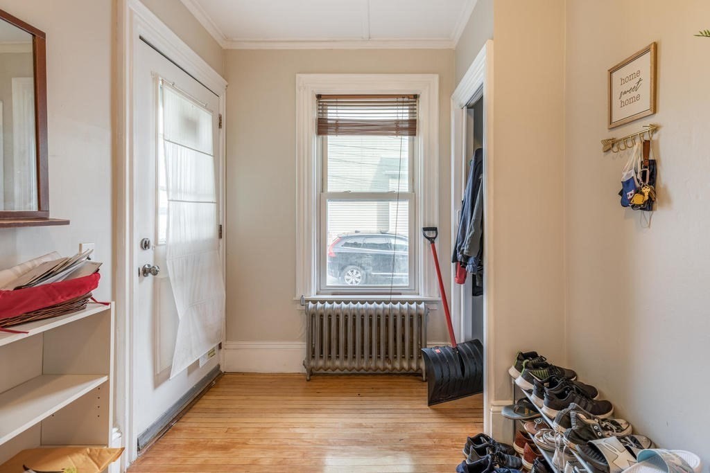 109 Chestnut Street, Unit 109 Waltham, MA 02453 - Photo 3 of 18 a view of an entryway with wooden floor and a bedroom