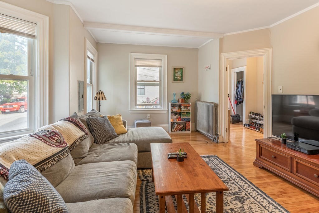 109 Chestnut Street, Unit 109 Waltham, MA 02453 - Photo 5 of 18 a living room with furniture and a flat screen tv