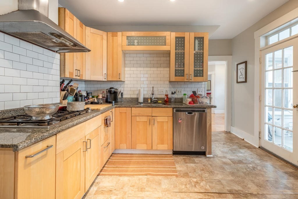 109 Chestnut Street, Unit 109 Waltham, MA 02453 - Photo 7 of 18 a kitchen with stainless steel appliances a sink stove and cabinets