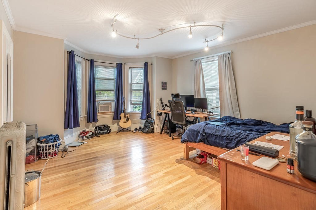 109 Chestnut Street, Unit 109 Waltham, MA 02453 - Photo 10 of 18 a living room with furniture a large window and a chandelier