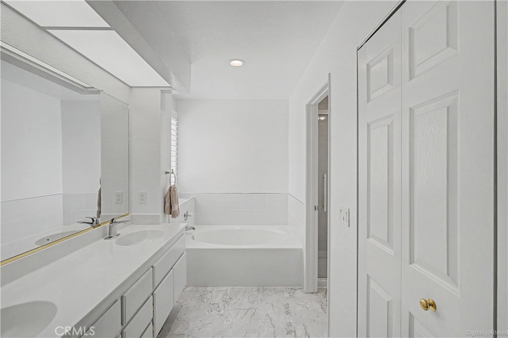 1129 Vía Nice Redlands, CA 92374 - Photo 13 of 23 a bathroom with a tub sink and mirror