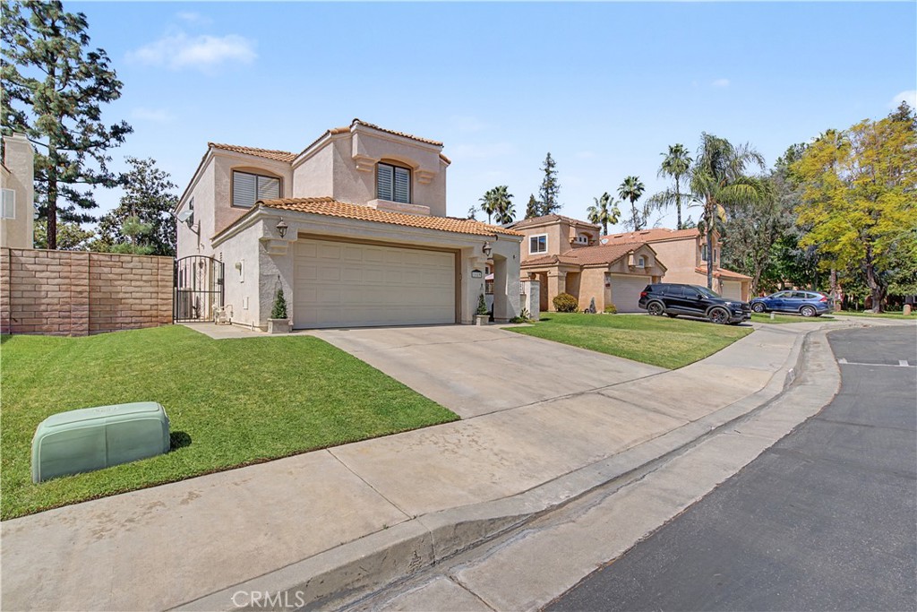 1129 Vía Nice Redlands, CA 92374 - Photo 23 of 23 a front view of a house with a yard and garage
