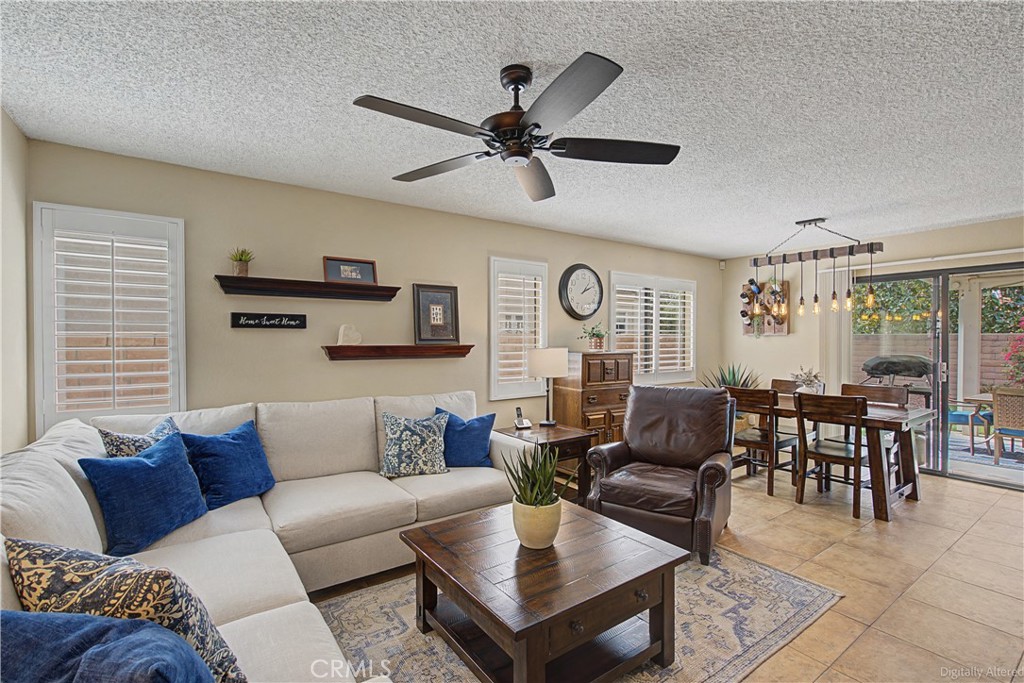 1129 Vía Nice Redlands, CA 92374 - Photo 3 of 23 a living room with furniture a clock and a window