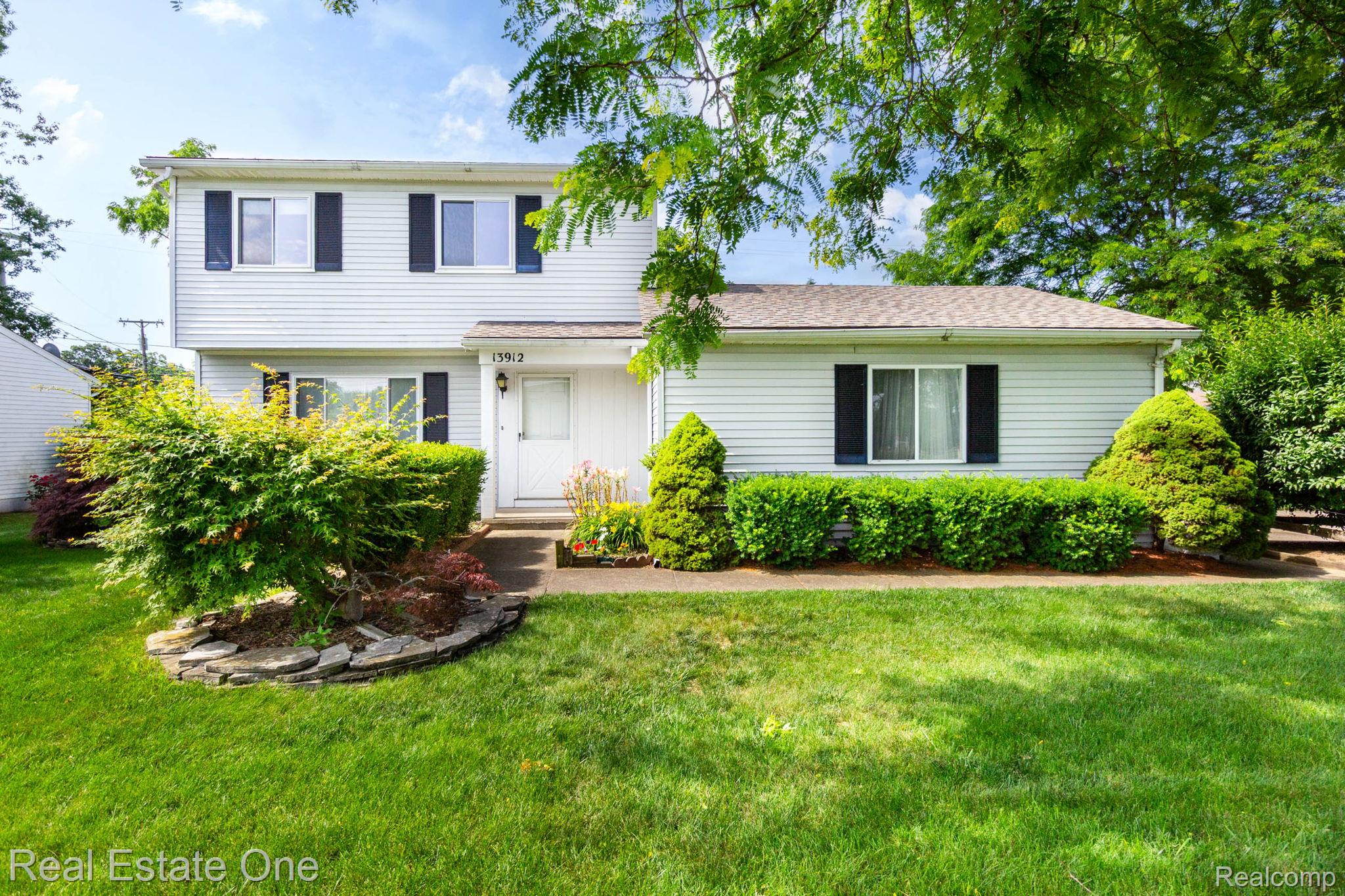 13912 Clinton River Road Sterling Heights, MI 48313 - Photo 1 of 43 Two-story residence featuring white siding and dark louvered shutters