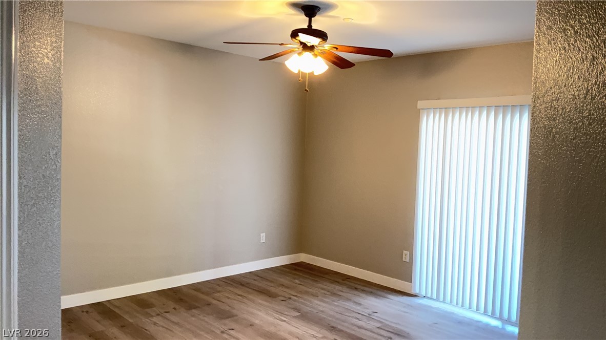 830 Carnegie Street, Unit 1024 Henderson, NV 89052 - Photo 11 of 27 Empty room with ceiling fan and light wood-style floors
