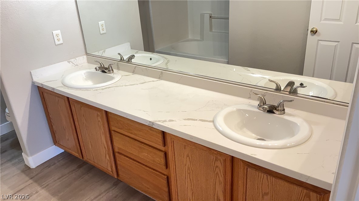 830 Carnegie Street, Unit 1024 Henderson, NV 89052 - Photo 13 of 27 Full bath with double vanity and light wood finished floors