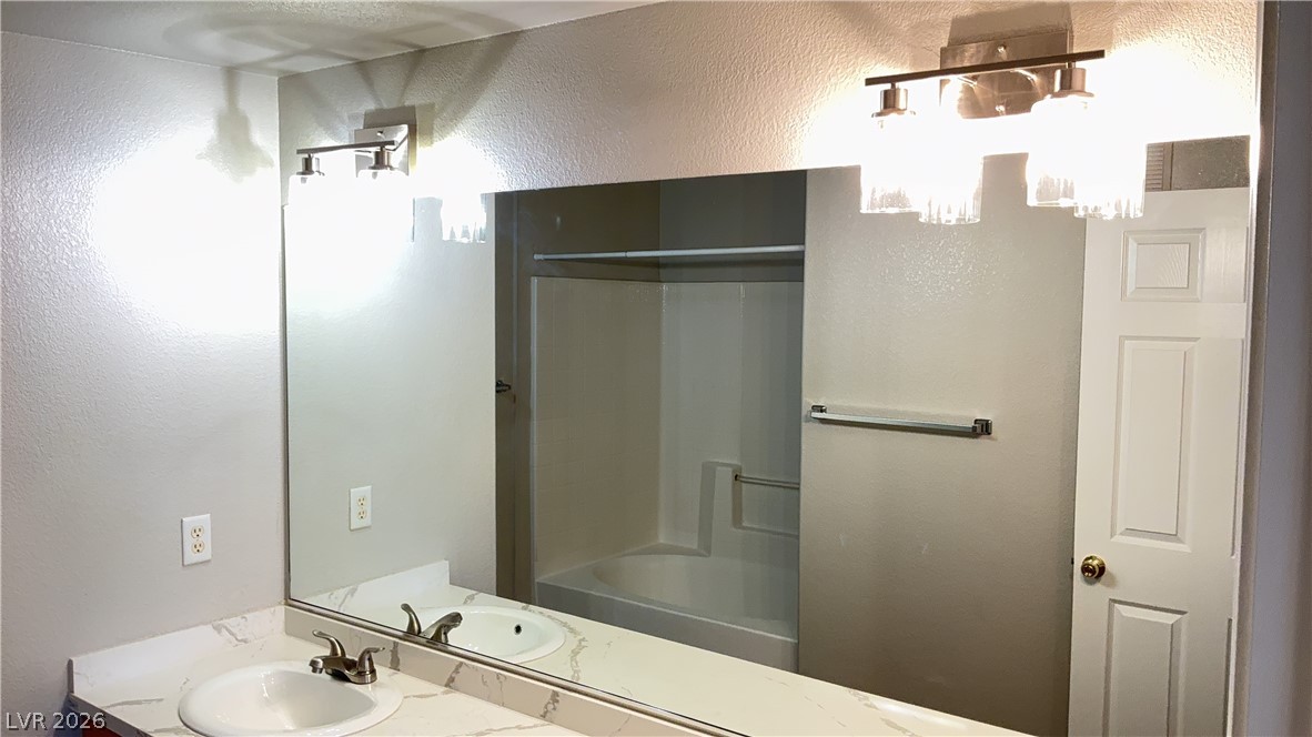 830 Carnegie Street, Unit 1024 Henderson, NV 89052 - Photo 14 of 27 Full bathroom with a textured wall, vanity, and bathtub / shower combination