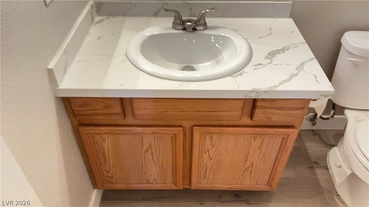 830 Carnegie Street, Unit 1024 Henderson, NV 89052 - Photo 18 of 27 Half bath featuring vanity and a textured wall