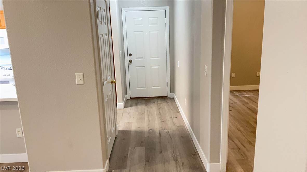 830 Carnegie Street, Unit 1024 Henderson, NV 89052 - Photo 2 of 27 Hall with baseboards and light wood-type flooring