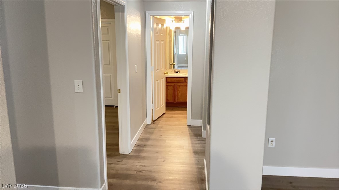 830 Carnegie Street, Unit 1024 Henderson, NV 89052 - Photo 7 of 27 Hallway featuring baseboards and wood finished floors