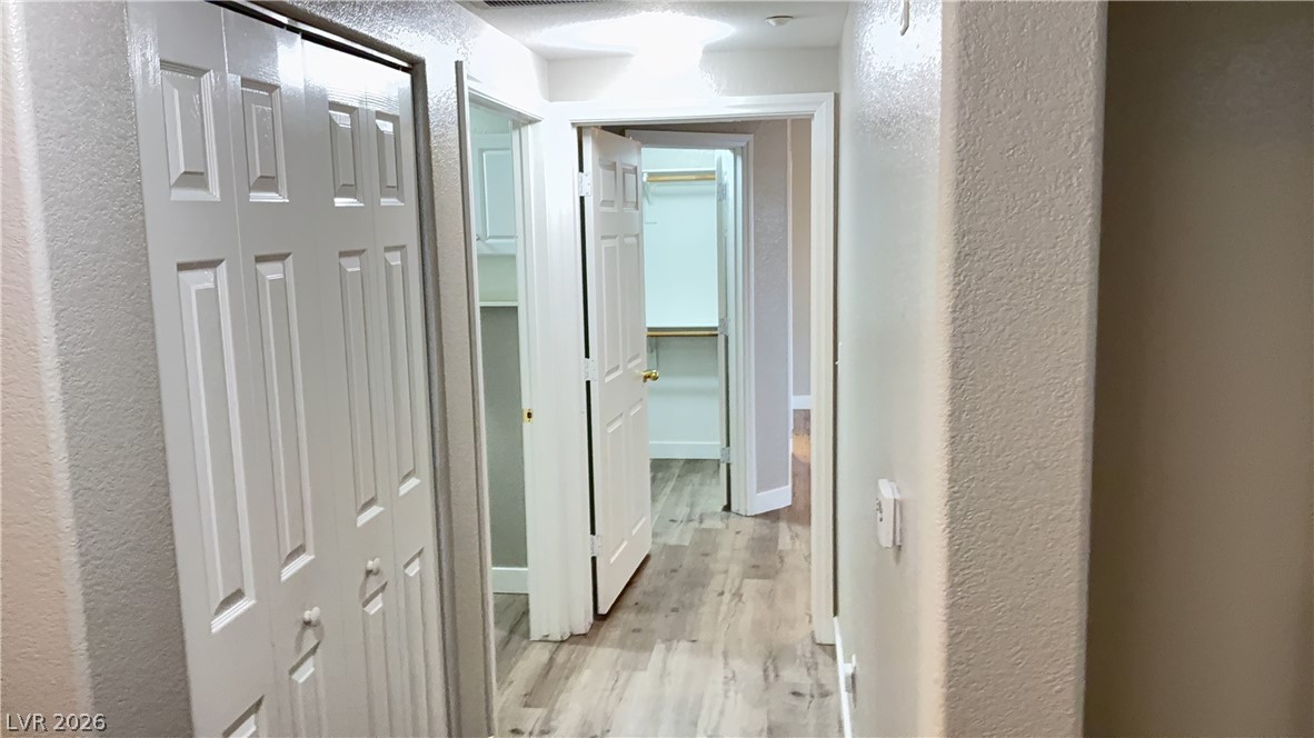830 Carnegie Street, Unit 1024 Henderson, NV 89052 - Photo 8 of 27 Hallway featuring a textured wall and light wood-style floors
