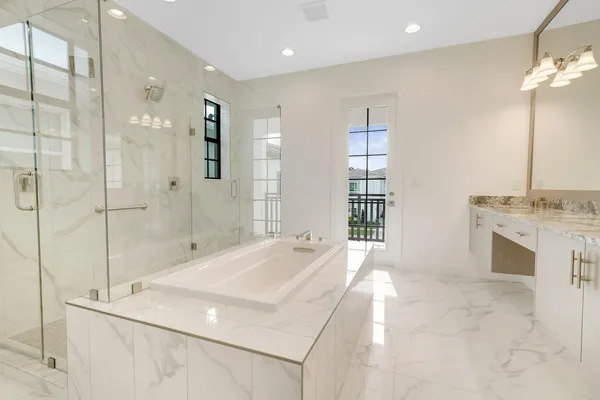 a view of a hallway with wooden floor and entryway