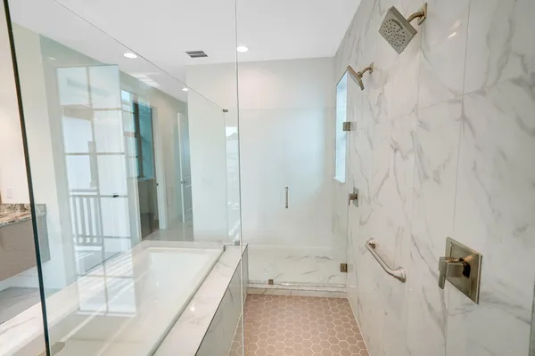a bathroom with a sink a toilet and shower