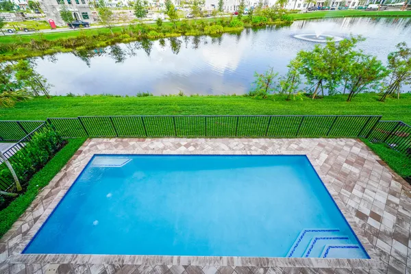 a view of a house with swimming pool and porch