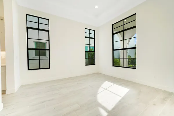 an empty room with windows and closet