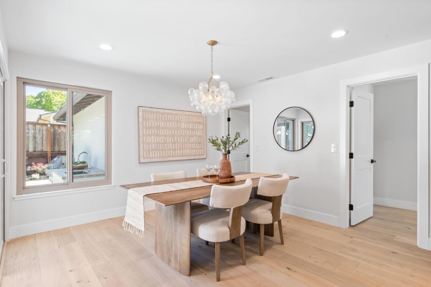 1961 Fordham Way Mountain View, CA 94040 - Photo 16 of 29 a dining room with chandelier a wooden table and chairs