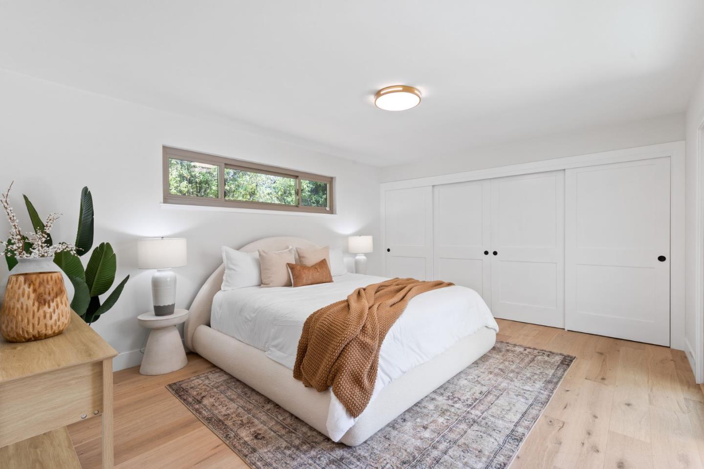 1961 Fordham Way Mountain View, CA 94040 - Photo 19 of 29 a spacious bedroom with a bed and a potted plant