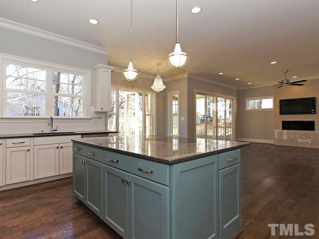 6415 Rosny Road Raleigh, NC 27613 - Photo 11 of 25 a kitchen with granite countertop a sink and a wooden floor