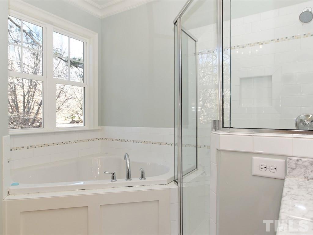 6415 Rosny Road Raleigh, NC 27613 - Photo 18 of 25 a bathroom with a sink and a bathtub