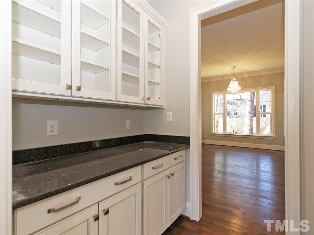 6415 Rosny Road Raleigh, NC 27613 - Photo 5 of 25 a kitchen with granite countertop white cabinets and a granite counter tops