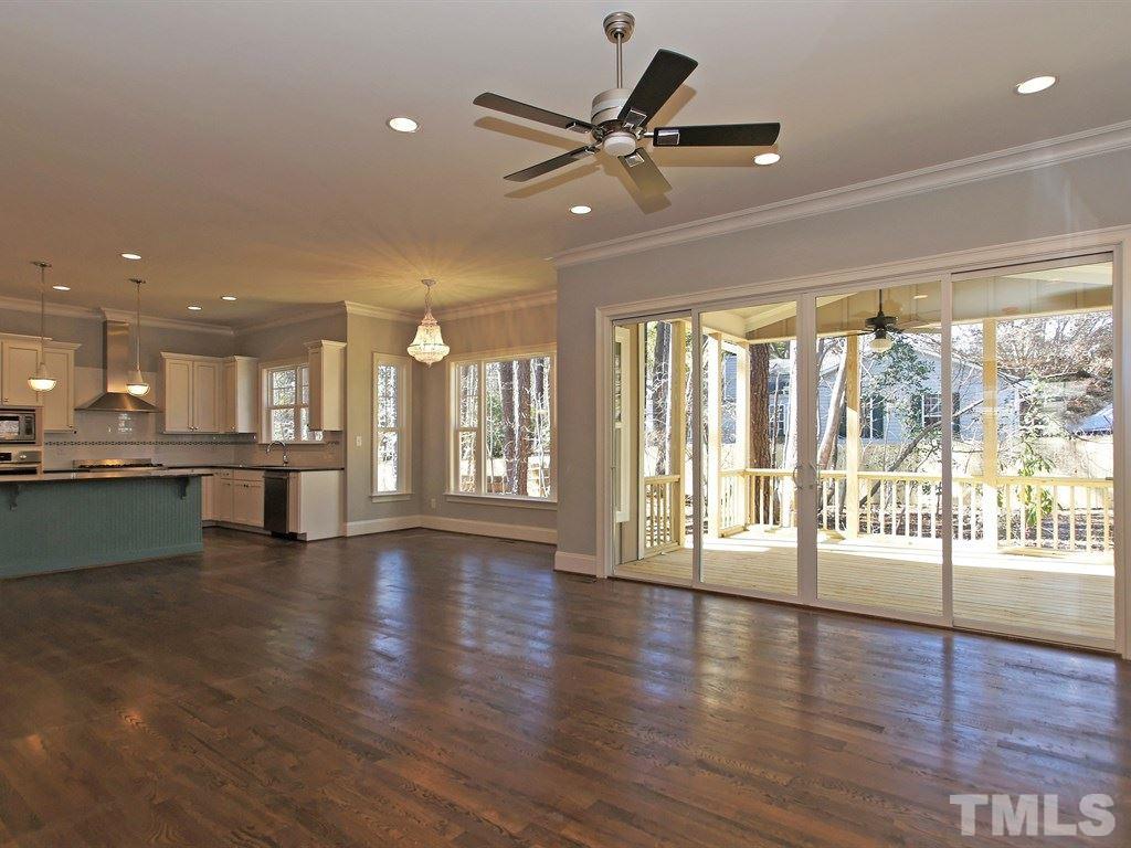 6415 Rosny Road Raleigh, NC 27613 - Photo 6 of 25 a view of an empty room with wooden floor and a window