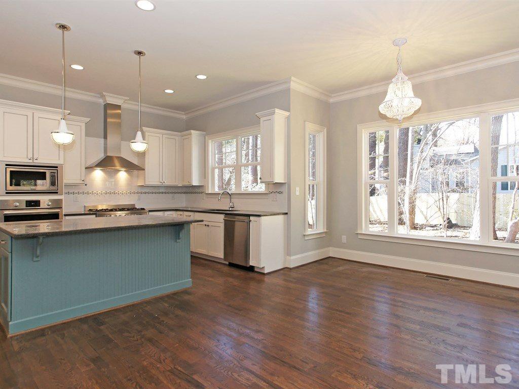 6415 Rosny Road Raleigh, NC 27613 - Photo 9 of 25 a large kitchen with lots of counter space a sink appliances and a large window