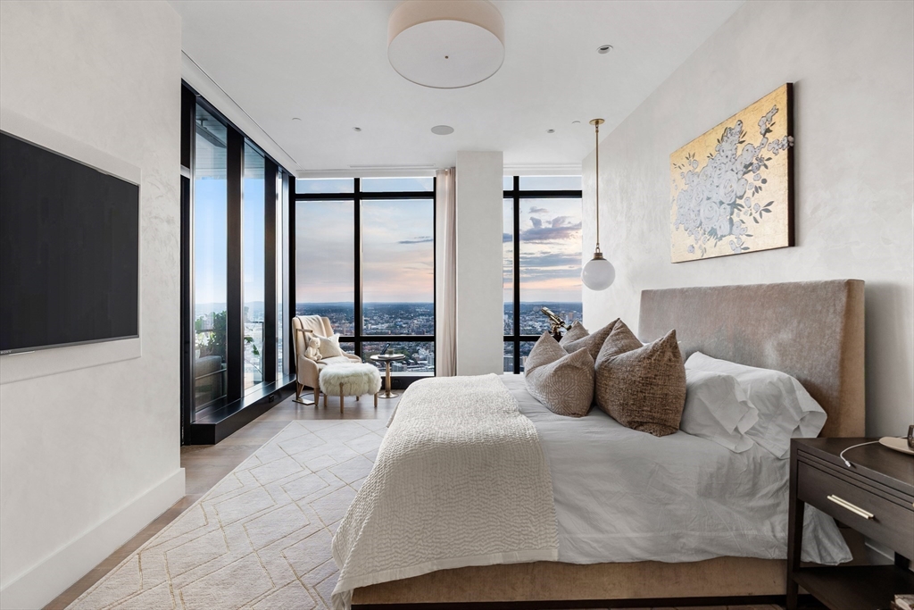 1 Franklin Street, Unit PH3E Boston, MA 02110 - Photo 24 of 42 a bedroom with a large bed and a flat tv screen