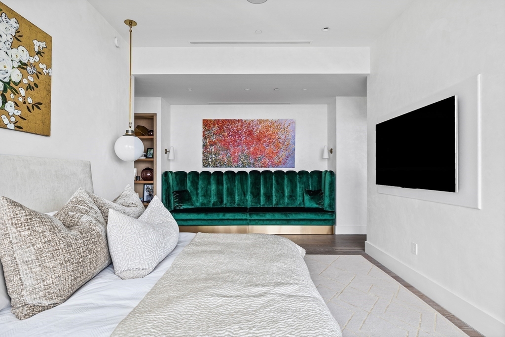 1 Franklin Street, Unit PH3E Boston, MA 02110 - Photo 26 of 42 a living room with furniture and a flat screen tv