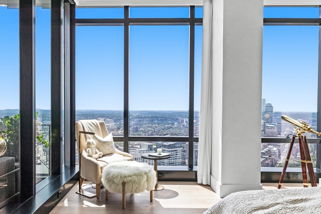 1 Franklin Street, Unit PH3E Boston, MA 02110 - Photo 27 of 42 a living room with furniture and a floor to ceiling window