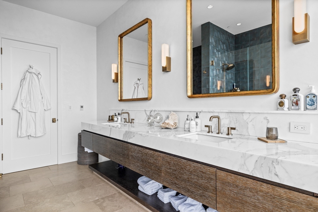 1 Franklin Street, Unit PH3E Boston, MA 02110 - Photo 28 of 42 a bathroom with a double vanity sink mirror and