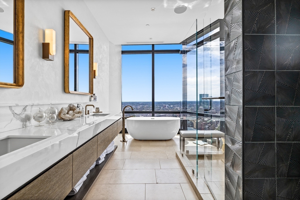 1 Franklin Street, Unit PH3E Boston, MA 02110 - Photo 29 of 42 a bathroom with a double vanity sink and a bathtub