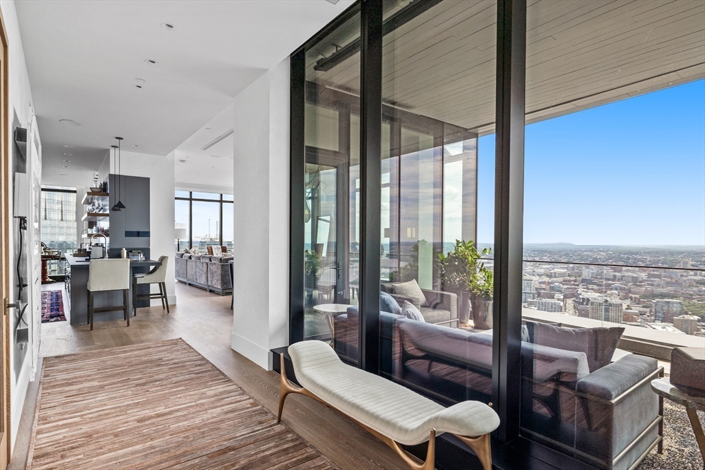 1 Franklin Street, Unit PH3E Boston, MA 02110 - Photo 5 of 42 a living room with furniture and a wooden floor