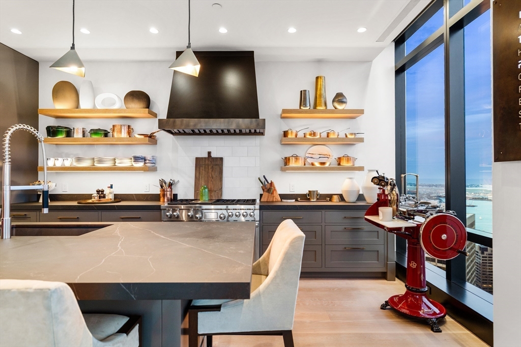 1 Franklin Street, Unit PH3E Boston, MA 02110 - Photo 7 of 42 a kitchen with microwave a stove and cabinets