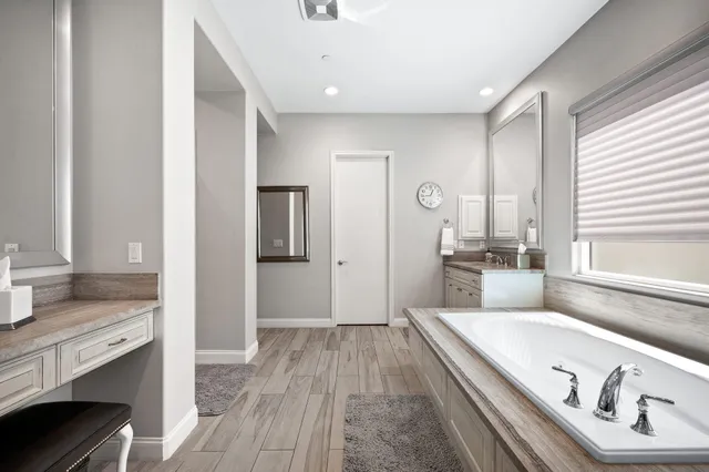 a view of a white house with a yard and sitting area