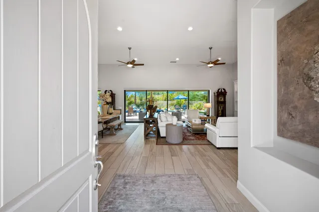 a living room with furniture and kitchen view